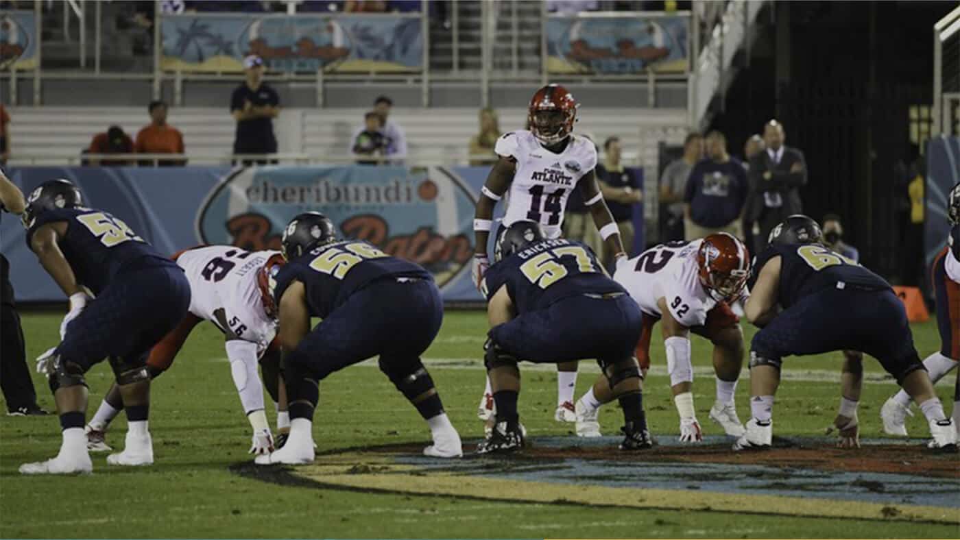 Football players lining up for the snap